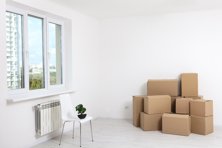 Moving into a new apartment. Move lots of cardboard boxes in an empty new apartment.の写真素材