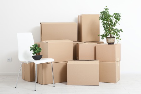 Moving into a new apartment. Move lots of cardboard boxes in an empty new apartment.の写真素材