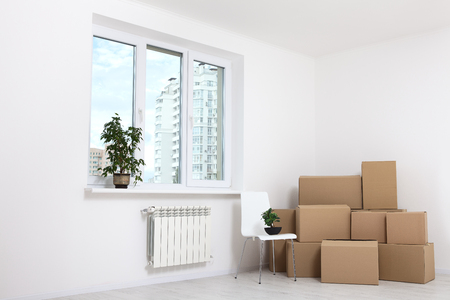 Moving into a new apartment. Move lots of cardboard boxes in an empty new apartment.の写真素材
