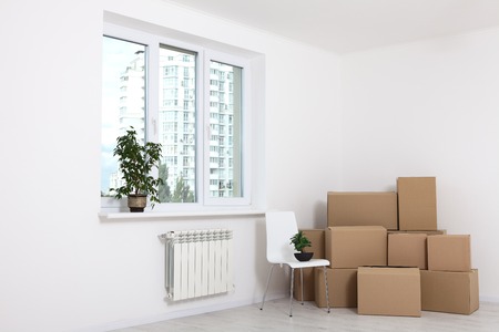 Moving into a new apartment. Move lots of cardboard boxes in an empty new apartment.の写真素材