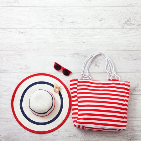 Summer accessories hat and bag on white wooden background.の写真素材