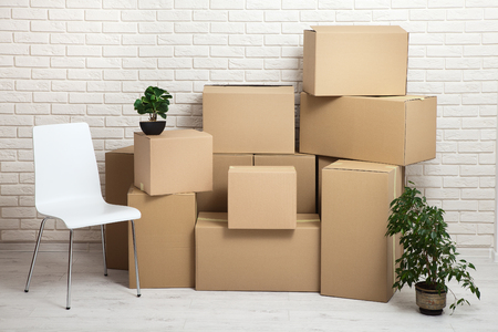 Moving into a new apartment. Move lots of cardboard boxes in an empty new apartment.の写真素材