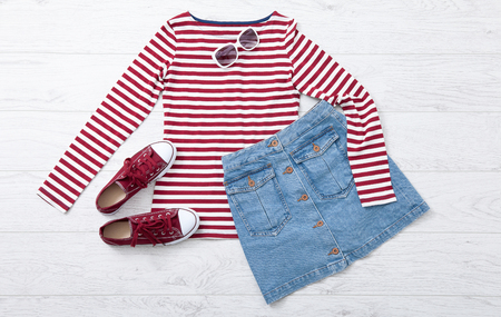 woman summer clothes and accessories collage on white wooden background, flat lay, top view mock upの写真素材