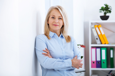 Portrait of beautiful middle aged businesswoman in officeの写真素材