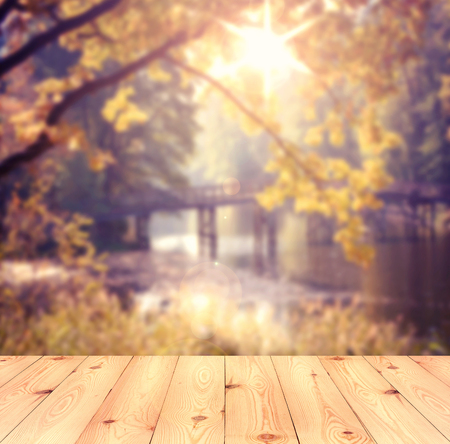 Empty table over blurred trees and river as background, product display templateの写真素材