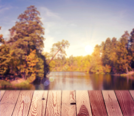 Empty table over blurred trees and river as background, product display templateの写真素材