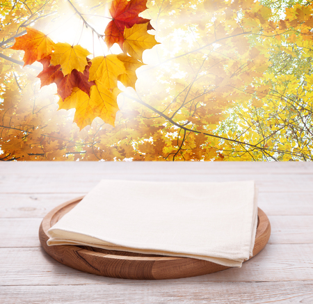 Pizza board with towel on wooden desk.の写真素材