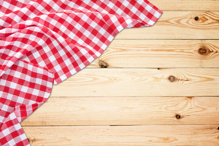 Vintage white wooden table with red checkered tablecloth. Top view mockup.の写真素材