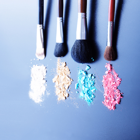 Makeup brushes on black background with colorful powder.の写真素材