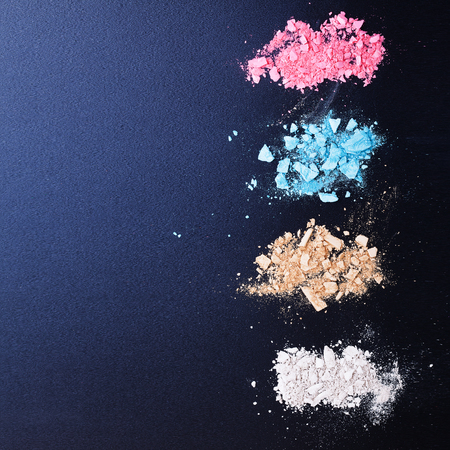 Makeup background. Multi colored powder on black board.の写真素材