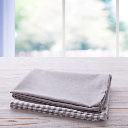 Napkin on the table and kitchen window blurred backgroundの写真素材