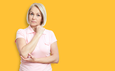 Middle-aged woman serious look at the camera isolated on white bの写真素材