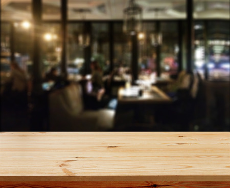 Wood table with blured background cafe , for your photo montage or product display. Space for placing items on the table.の写真素材