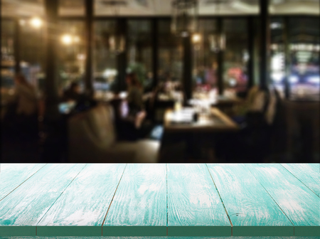 Wood table with blured background cafe , for your photo montage or product display. Space for placing items on the table.の写真素材