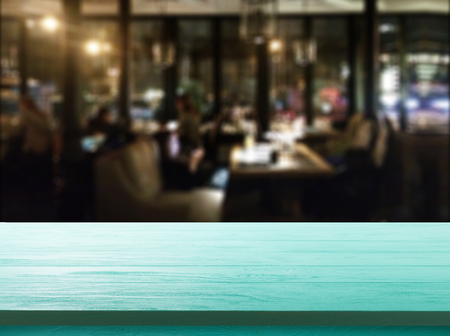 Wood table with blured background cafe , for your photo montage or product display. Space for placing items on the table.の写真素材