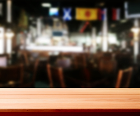 Wood table with blured background cafe , for your photo montage or product display. Space for placing items on the table.の写真素材