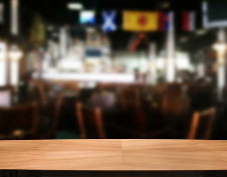 Wood table with blured background cafe , for your photo montage or product display. Space for placing items on the table.の写真素材