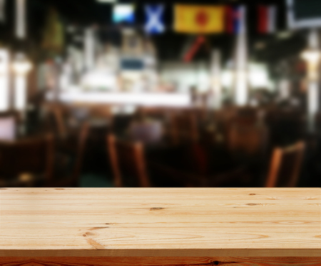 Wood table with blured background cafe , for your photo montage or product display. Space for placing items on the table.の写真素材