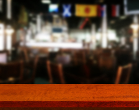 Wood table with blured background cafe , for your photo montage or product display. Space for placing items on the table.の写真素材