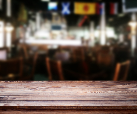 Wood table with blured background cafe , for your photo montage or product display. Space for placing items on the table.の写真素材