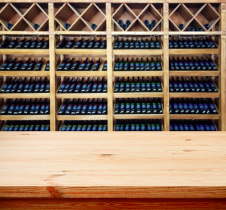 Wood table with blured background wine bar, for your photo montage or product display. Space for placing items on the table.の写真素材