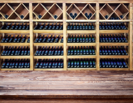 Wood table with blured background wine bar, for your photo montage or product display. Space for placing items on the table.の写真素材