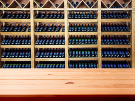 Wood table with blured background wine bar, for your photo montage or product display. Space for placing items on the table.の写真素材
