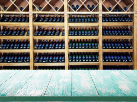 Wood table with blured background wine bar, for your photo montage or product display. Space for placing items on the table.の写真素材