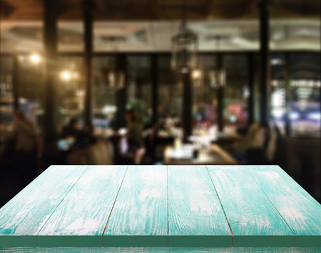 Wood table with blured background cafe , for your photo montage or product display. Space for placing items on the table.の写真素材