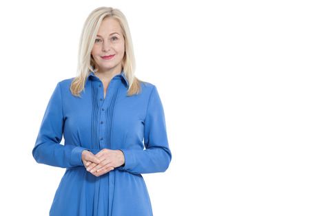 Friendly smiling middle aged woman in blue dress isolatedの写真素材