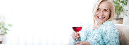 Closeup portrait of female customer drinking red wine.の写真素材