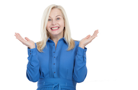 Portrait of happy middle aged woman. Surprised happy woman looking with her mouth open and holding her arms out in excitement. Isolated over white backgroundの写真素材