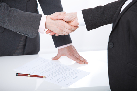 Business handshake. Two business women shake hands with each other to sign a successful dealの写真素材