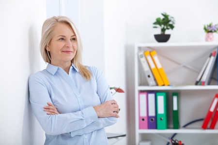 Portrait of beautiful middle aged businesswoman in officeの写真素材