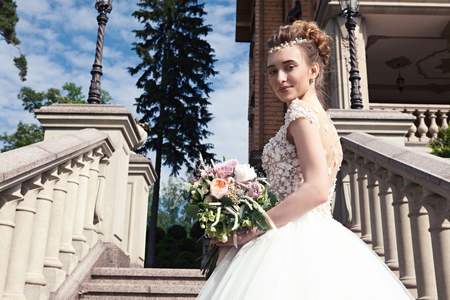 Young bride in a white dress with a beautiful wedding bouquet onの写真素材