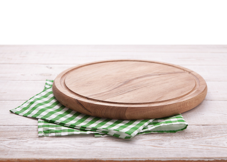 Pizza board, with napkin on wooden table isolated. Top view mockupの写真素材