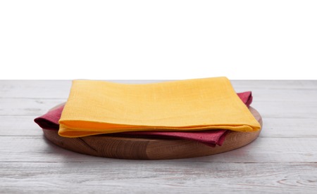 Pizza board, with napkin on wooden table isolated. Top view mockupの写真素材
