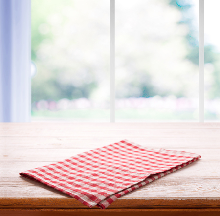 Napkin on the table and kitchen window blurredの写真素材