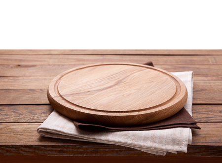 Pizza board, with napkin on wooden table isolated. Top view mockupの写真素材