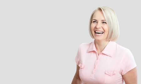 Friendly smiling middle-aged woman isolated on whiteの写真素材