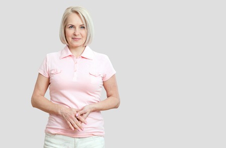 Friendly smiling middle-aged woman isolated on whiteの写真素材