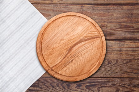 Table cloth and pizza board on vintage wooden table. Top view mockupの写真素材