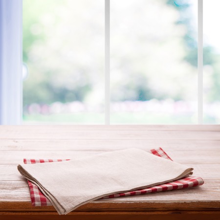 Napkin on the table and kitchen window blurredの写真素材