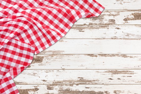 Vintage white wooden table with red checkered tablecloth. Top view mockup.の写真素材