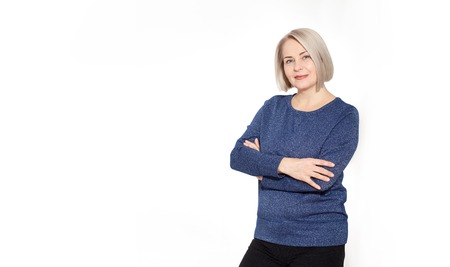 Attractive middle aged woman with folded arms on whiteの写真素材