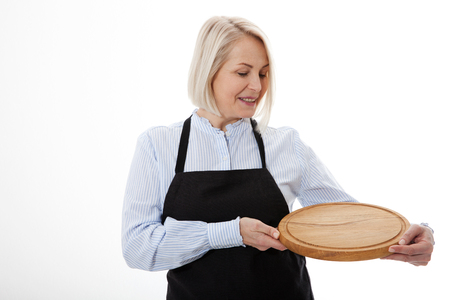 Attractive woman gives empty pizza board for your advertising products isolated on whiteの写真素材