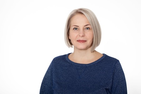 Attractive middle aged woman with folded arms on whiteの写真素材