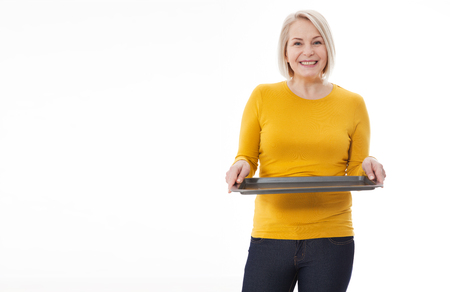 Woman gives empty tray for your advertising products isolated on whiteの写真素材