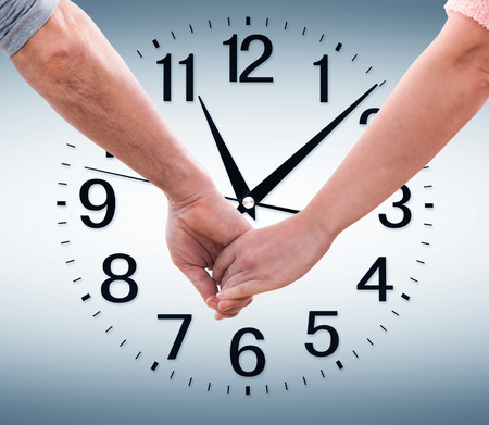 Couple holding hands on the  big clockの写真素材