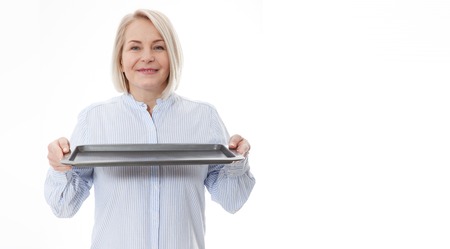 Woman gives empty tray for your advertising products isolated on whiteの写真素材